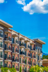Exterior of a residential building under blue sky with clouds on a sunny day