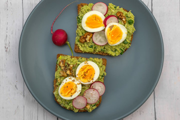 Sandwiches with avocado guacamole  fresh radish and boiled egg