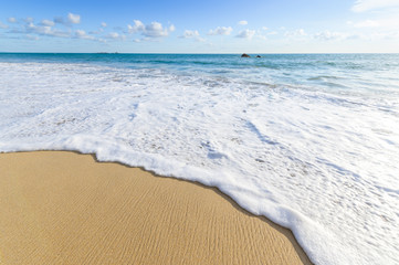 Soft wave of blue sea on sandy beach. Background.