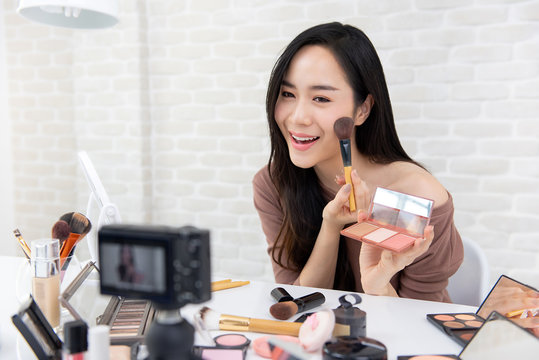 Beautiful Asian woman professional beauty vlogger recording make up tutorial video