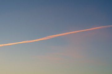 Fototapeta na wymiar Trail from the plane in the evening sky