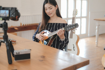 blogger live broadcasting music instrument tutorial on social media. vlogger recording online vlog...