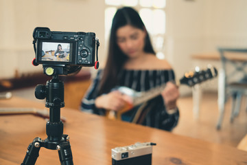 blogger live broadcasting music instrument tutorial on social media. vlogger recording online vlog...