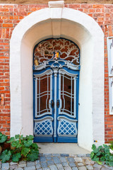 Fototapeta na wymiar Old blue wooden front door in house. Luneburg. Germany