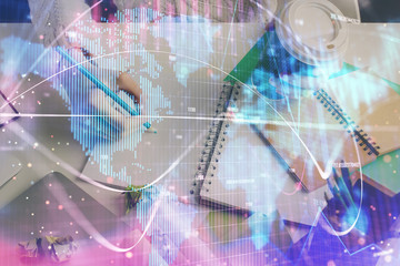 International business hud over woman's hands writing background. Concept of hard work. Double exposure