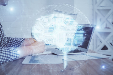 Man typing on keyboard background with brain hologram. Concept of big Data. Double exposure.