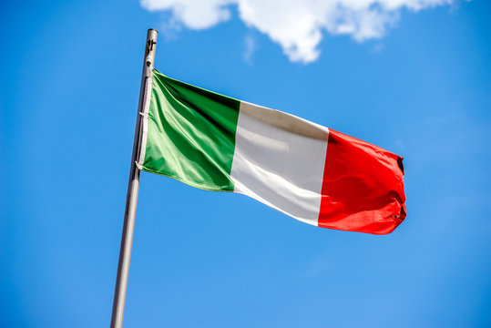 Flag Of Italy flying on a metal flag pole 