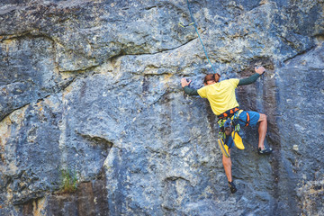 Man climbs rock.