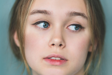 Fototapeta premium Portrait of beautiful young woman with brown hair. Closeup face of a pretty caucasian model looking at camera
