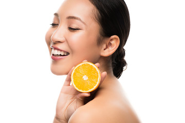 beautiful smiling asian woman holding orange, isolated on white