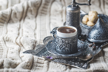 Traditional turkish coffee and turkish delight on textile background
