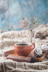 Hot Coffee cup on tray over background of the plaid