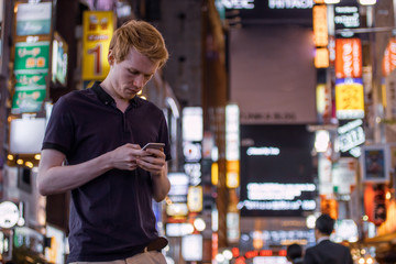 A handsome man looking at his phone