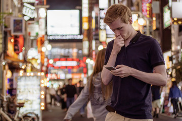A handsome man looking at his phone