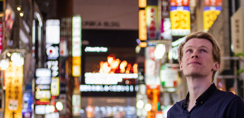 A handsome blond tourist looking of to the front