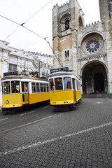 Naklejka na ściany i meble two old trams near Cathedral in Lisbon