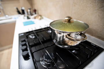 Prepared delicious dinner food pasta or soup or stew in big steel pan, cool down under lid, stand...