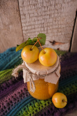 Full jar of apple jam on the wooden background. Autumn fall concept, closeup of harvest, pickling and conservation