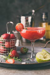 Ice Strawberry alcohol cocktail with lime and rum in a glass