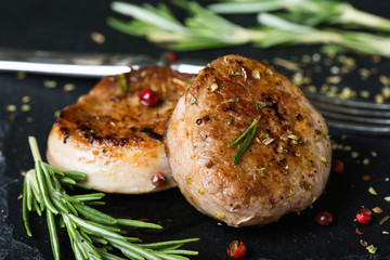 Fried pork tenderloin medallions with spices and herbs