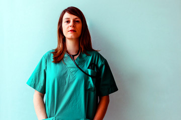 portrait of a young female doctor with an assertive and intense gaze against white background