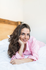 Peaceful woman lying on her duvet in her bedroom