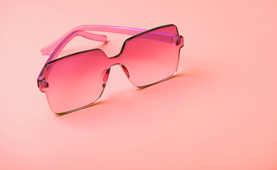 pink fashion glasses on bright pink background. Fashion and style design. Sunglasses on pink background. Creative fashion minimal concept. copy space