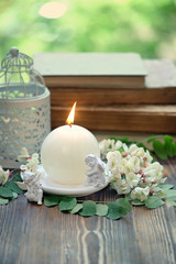beautiful tender scene with candle, flowers and angels. spring or summer romantic vintage still life. copy space