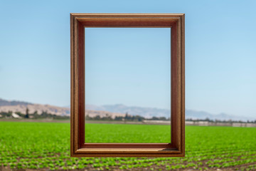 picture frrame with farm and blue sky