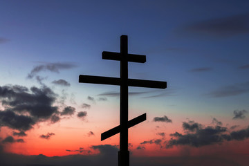cross on blue sky. silhouette of Christian cross on fire sky