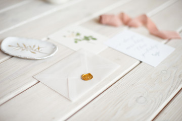 Feminine wedding desktop mock-up with blank paper card and Eucalyptus populus branch on white shabby table background. Empty space. Styled stock photo, web banner. Flat lay, top view