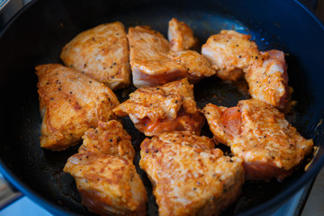 Roast meat in a pan with a Golden crust in large chunks. Finished meat in a pan. Side view