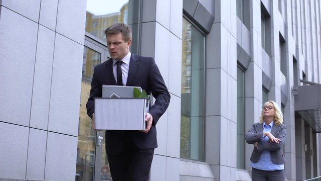 Strict business lady pointing exit, male assistant dismissal, work competition