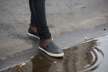 Feet of person in a puddle