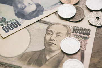 Japanese yen money bills and coins on wood table background