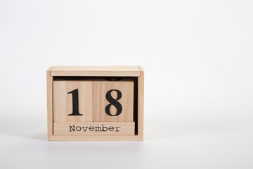 Wooden calendar November 18 on a white background