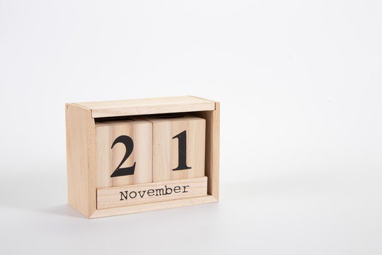 Wooden calendar November 21 on a white background