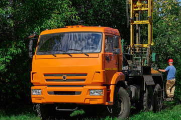 Taking a rock sample for analysis. Drilling equipment geologists on a truck. Engineering surveys in geology for construction