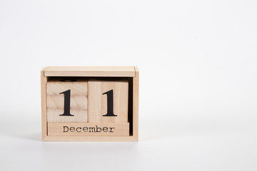 Wooden calendar December 11 on a white background