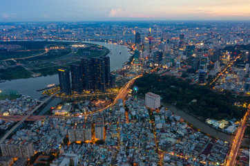 Top View of Building in a City - Aerial view Skyscrapers flying by drone of Ho Chi Mi City with development buildings, transportation, energy power infrastructure.