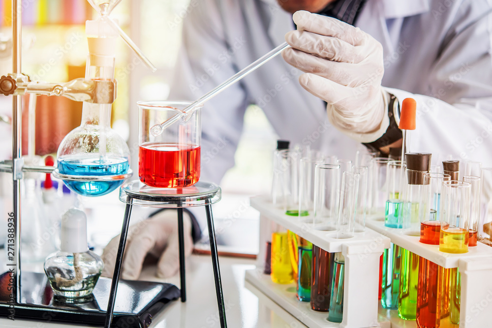 Wall mural scientist working at laboratory with chemical containing in beaker and lab test tube