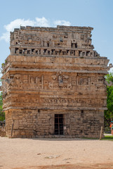 Small Mayan temple, adorned with engraved stones, in the archaeological area of Chichen Itza, on the Yucatan peninsula