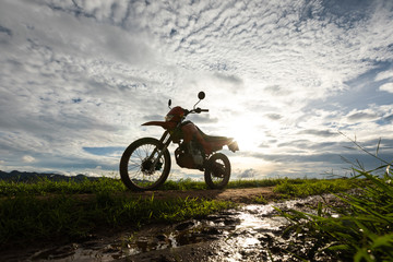 motocross stand on soil road with sunset cloud sky background