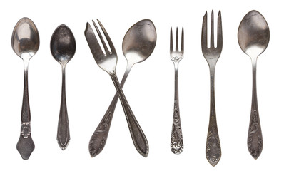 Beautiful old vintage spoons and knife isolated on white background. Top view. Retro silverware