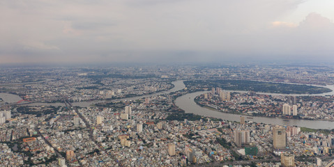Top View of Building in a City - Aerial view Skyscrapers flying by drone of Ho Chi Mi City with development buildings, transportation, energy power infrastructure.