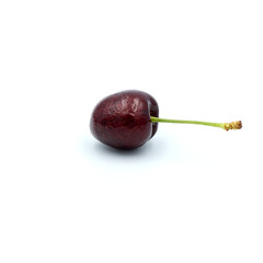 Reddish-purple cherries that are isolated on the white background