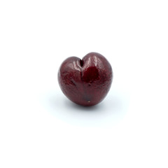 Reddish-purple cherries that are isolated on the white background