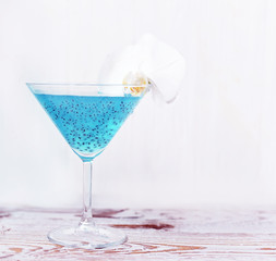 Refreshing healthy drink with chia seeds and white orchid flower. The atmosphere of summer and relaxation. Proper nutrition.