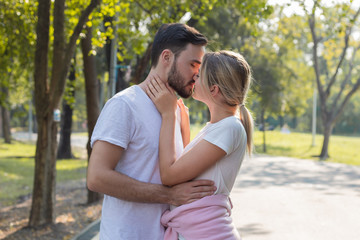 Fototapeta premium Couples standing kiss and hugging in the park.
