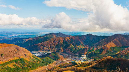 Mountain range with blue sky and clouds during autumn